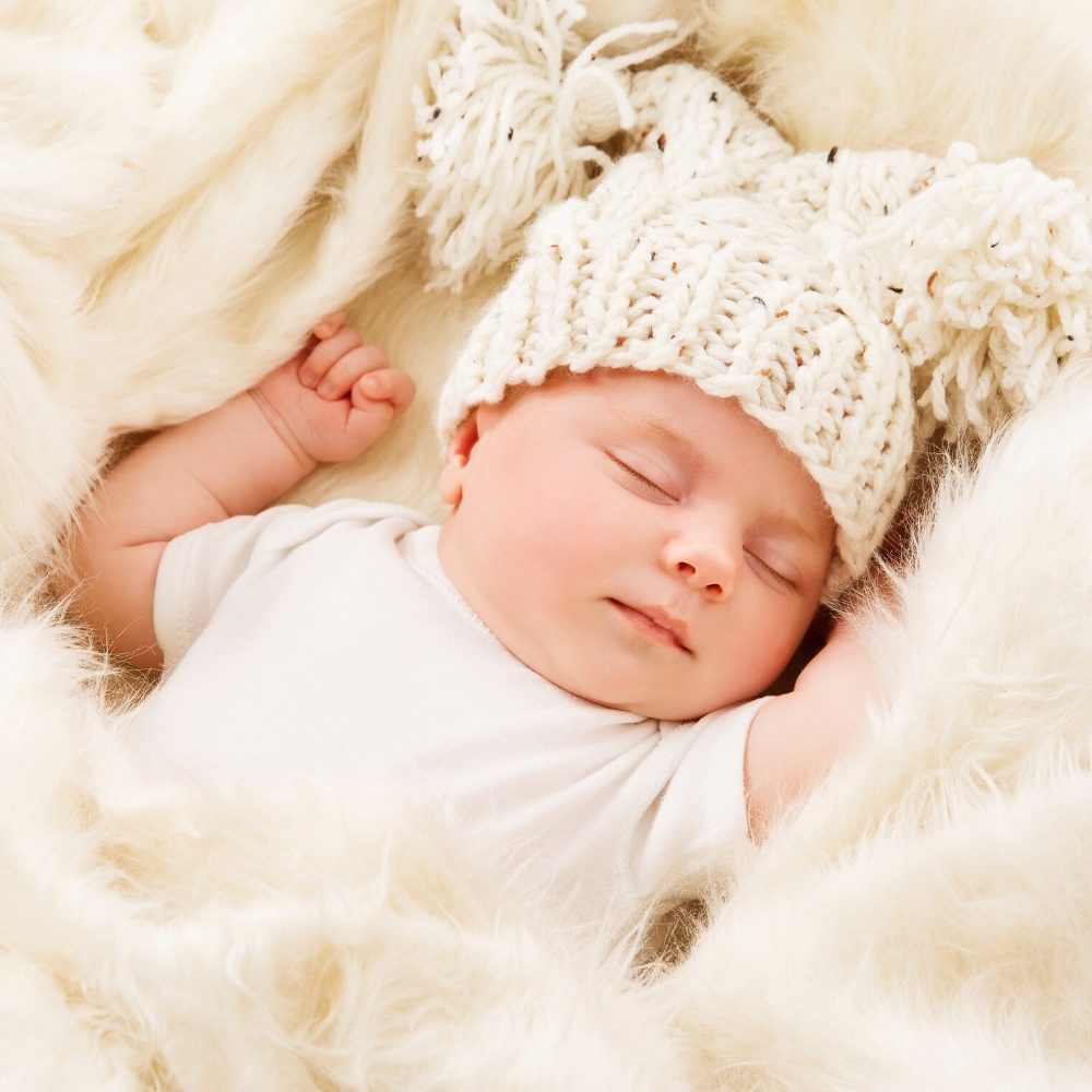 Bébé avec bonnet en laine, séance photo naissance en studio à Paris